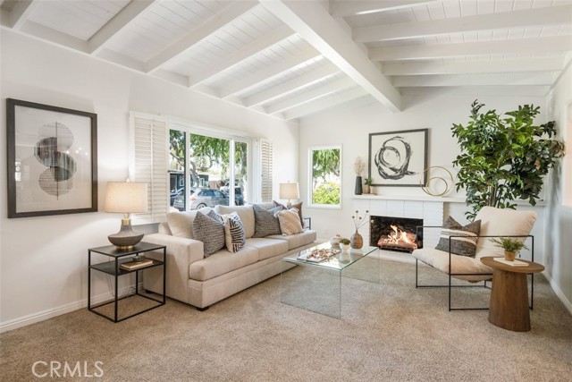 Gorgeous living room with fireplace and beamed ceilings.