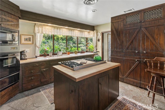 Unique Country Kitchen evokes the ranch feel with modern basics, like a viking cooktop!