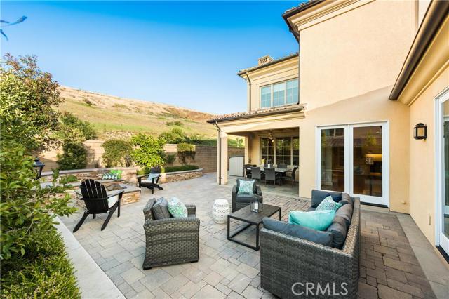 81 Livia Irvine, California Escape the world and enjoy the tranquility behind the gates of newly developed Laguna Altura. Nestled in the hills of South Irvine, this Toscana Residence 3 boasts 3236 SF of gracious living on a premium 4820 oversized lot at the end of cul-de-sac location adjacent to rolling hills and peaceful nature trails. This 4 bedroom, 4 En-suite bathroom home plus loft has more upgrades than the model! Enjoy Provenza Wood Flooring, Formal Entry with open Living Room and extended Dining Room. Inviting fireplace. Large Pocket Doors line the back wall for plenty of morning sunshine! Downstairs full bed & bath. Chef's dream kitchen with oversized island with Santa Cecilia granite, wine refrigerator and veggie sink. Thermador kitchen appliances. Enjoy clean air and water with Whole House Electronic Air Purification System and Reverse Osmosis Water Filtration System. Feel secure with Security System C-M with pet-immune motion sector. Enjoy your music and entertainment with 5.1 Surround Sound with 3x room Audio Speakers. Professionally landscaped yard with covered patio, fire pit and spacious yard. Ideally located in Orange County only minutes from Laguna Beach while being conveniently located next to shopping and entertainment. Award-Winning Irvine School District.