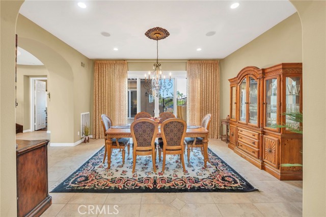 Wider view of formal dining room.