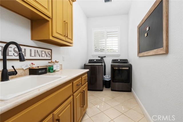 Laundry room with sink and cabinets