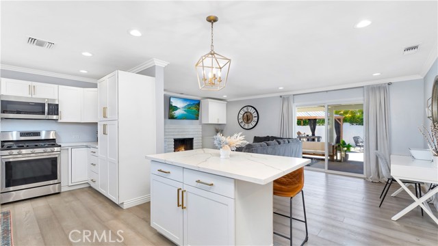 JUST LISTED - This Perfectly Reimagined Entertainer's Dream home is an alluring blend of New Modern Elegance and California Beach Casual.  This rare move-in-ready, single-level, 3 Bed/2 Bath Cypress School District Home is ready and waiting for you.  Meticulously renovated from the inside-out, it will provide endless ways to enjoy life with those who matter most.  Immediately upon entering, the thoughtful clean and open design, convenient smart features, warm wide-plank flooring, elegant Quartz Counters and impeccable details crisply meld this home into the safe and restful haven you've been looking for.  You'll enjoy the lavish and clean modern design of your private Master-en-suite bath that provides the convenience and privacy sought by most deserving homeowners today.  Enjoy the innovative island-style open floor plan that seamlessly blends the kitchen and preparation zone with the family/gathering area that effortlessly extends out under the massive new Alumawood-type expanded outdoor covered living area - creating endless possibilities for future shared moments and memories.  Everything just appears to be Bigger, Brighter and Better in this well-loved home.  A plethora of thoughtful amenities include; USB-ready outlets, full copper supply lines throughout, new ABS sewer line w/cleanouts, custom fire-side cabinets, Bluetooth capable Speakers Bathroom Vent/Lights, Ecobee Smart Thermostat, custom closet interiors, SimpliSafe Home Security System, Attached 2-car Garage w/polished epoxy Floors, show-car lighting, pull-down attic stairs to a reinforced storage area, and a quiet side-mounted garage door opener.  Everything was carefully considered in this beautiful makeover; including the sustainable Ipe wood fenced-in yard, maintenance-free backyard w/artificial grass, elegant bistro lighting, tankless water heater, 'August" Smart Lock door security and the must-have Side-by-Side Driveway Parking.  Experience comfortable casual modern living at its finest in this one-of-a-kind, award-winning Cypress School District Modern Makeover Masterpiece.