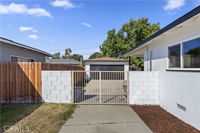 Driveway with Gate to Backyard and Detached Garage