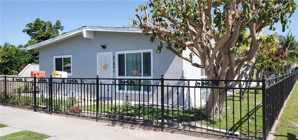Rare Corner Location Paramount Duplex! Great Investment Opportunity or Live in one and use the income of the other to qualify. Possible FHA financing with 3.5% down. Both units have new exterior paint and all new low E vinyl windows. Large wrought iron fenced yard with fruit trees. Unit one 3145 is a single level home with 3 bedrooms and recently remodeled bath (another full bath in oversized one car garage), living room with beamed ceiling, formal dining area and kitchen with granite counters. Unit two 3147 is above an oversized two car garage and features one bedroom, remodeled bath, living room (could be bedroom 2) and dining in kitchen. The oversized two car garage has been split in to 2 oversized one car garages (one for each unit). Separate gas and electric meters. Long term tenants Leasing month to month. Property is close to freeways, shopping centers, dining, parks and schools. Excellent corner location with lots of parking.