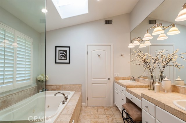 Spa-like bathroom with overhead shower and spa tub