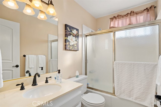 Upstairs full bathroom with tub/shower window low flow toilets and updated light fixture and faucets