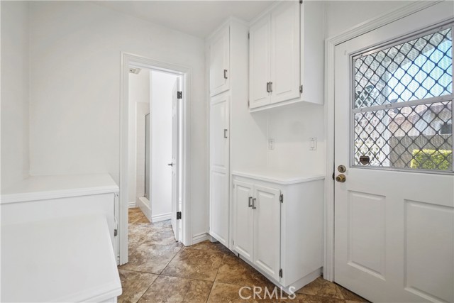 Back door that leads to side yard and gate and door to garage.