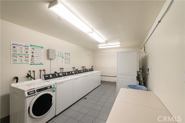 Laundry room located past the lobby. There is another laundry room closer to the unit.