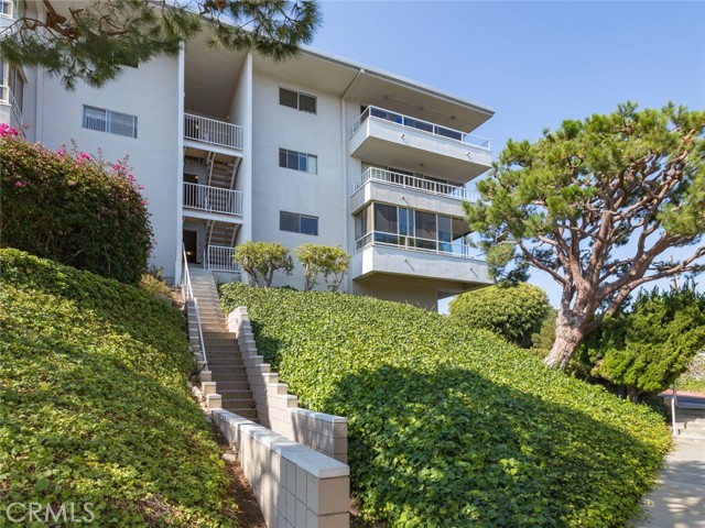 Side stairs leading to building. The first story (where unit is located) is significantly above ground affording the exceptional views. There is another path at other end of building that has only a few steps. And there is an elevator in building as well.