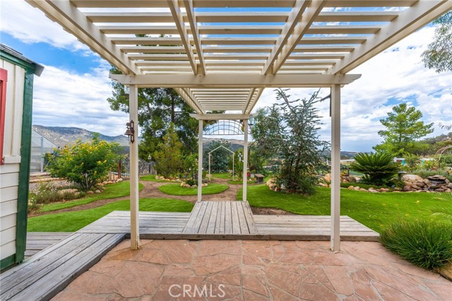 Back yard has trellises and paths