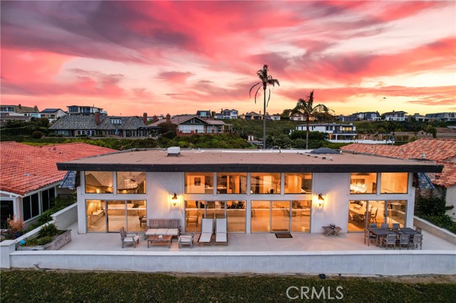 Truly an incredible opportunity for a "Single Level" custom home with spectacular "Ocean, White Water and Catalina Views" located within the coveted 24-hr guard gated community of Niguel Shores! This extremely open and spacious (approx) 3400sqft residence, is light and bright boasting the "Great room concept" containing 3 bedrooms, 3 baths, cathedral ceilings, floor to ceiling windows/doors, a dramatic custom fireplace located in the living/family room, a separate office/den, oversized main floor laundry room with sink, stone counters & skylight, newer heating and air conditioning system, electric draperies, bar area with wine cooler, a center island gourmet kitchen featuring stainless steel appliances inclusive of a Thermador 6- burner range, double ovens, built-in Refrigerator/freezer, microwave, warming drawer, dishwasher, custom cabinetry as well as custom granite countertops. Skylights located in the kitchen, laundry and office/den area allow an abundance of natural light within the residence. This "no steps" single level residence is situated on approximate 7500sqft site, contains a large grass courtyard area ideal for pets and entertaining. This "non- descript" custom residence features an outstanding rear yard deck displaying phenomenal ocean and panoramic views of both Catalina and San Clemente islands, provides for incredible "indoor/outdoor" entertaining and living! The master suite contains floor to ceiling doors/windows, walk-in closet, two separate vanity areas, jacuzzi-type tub and walk-in shower. A secondary bedroom, contains direct access to the front courtyard! Additionally, there is an oversized 3-car garage with multiple openers, built-in cabinetry, epoxy floors and significant additional lighting. Throughout the residence is the lavish use of stone including  honed Crema 24x24 Marfil flooring from Spain, Quartz plus Juparana and Barricato granite. Walk to the Ritz Carlton Resort as well as the world renowned Salt Creek Beach with its surfing breaks and the sands of the Pacific Ocean. Minutes to the Dana Point Harbor and its Lantern District with its numerous dining and shopping establishments. This 24-hr guard gated "oceanfront" community has direct beach access and a bluff top "ocean front" park. The HOA amenities including tennis, pickle ball, Jr Olympic sized pool, sports courts, playground, barbeque area, recreation center and more! Seldom do these "ocean close" single level homes come to our market place with this location!