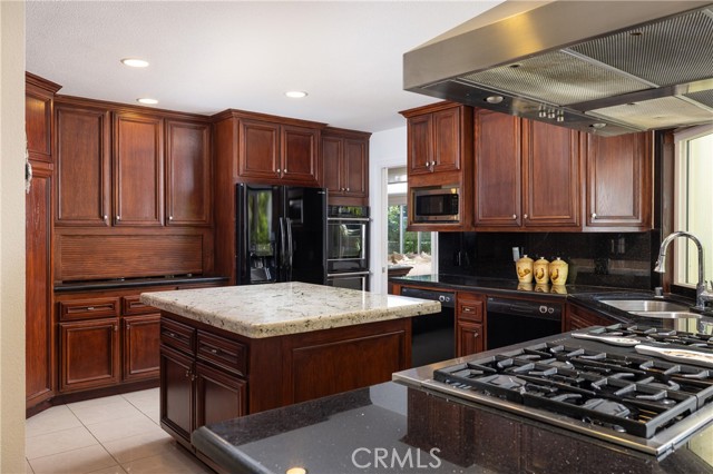 Double ovens and dishwashers, a 6-burner cooktop, center island and ample storage create a chef's delight.