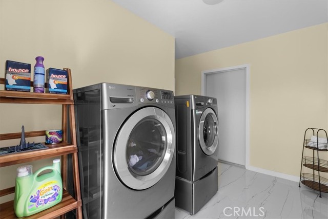 Large laundry room on main floor with access to garage and backyard