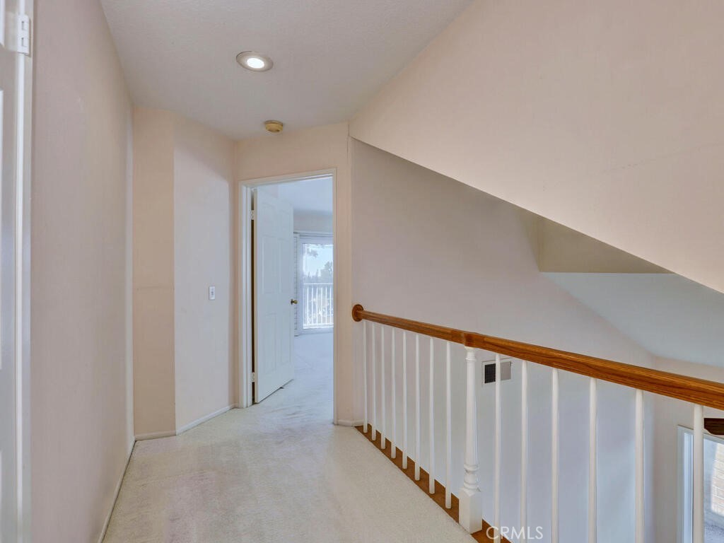 Landing to primary suite...also a large storage closet in hallway