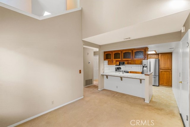 Breakfast bar separates kitchen and dining room.