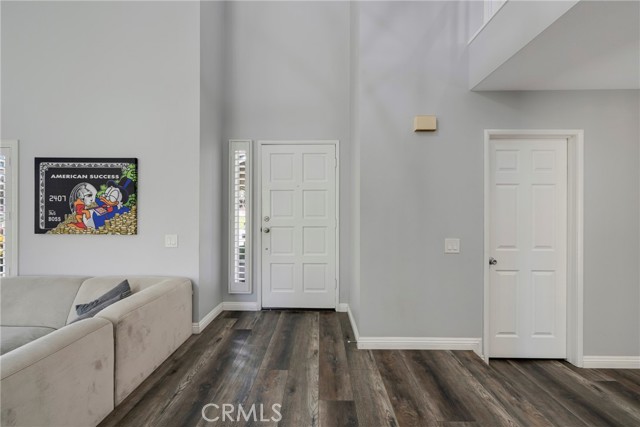 FRONT DOOR ENTRY LEADS TO VINYLY FLOORING THROUGHOUT.