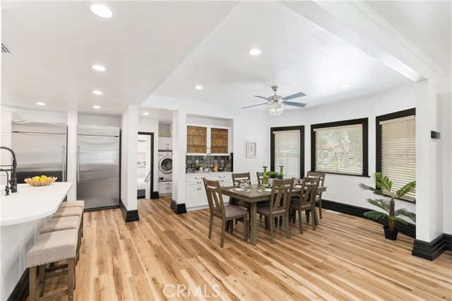 The dining room has windows looking toward the Houghton side of the front yard. It is open to the kitchen bar too.