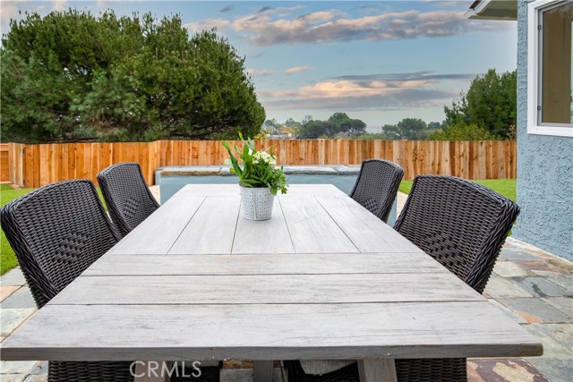 Outdoor dining with a view of the city lights, harbor, and Mountains