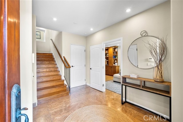 Entryway with elevator and access to bonus room