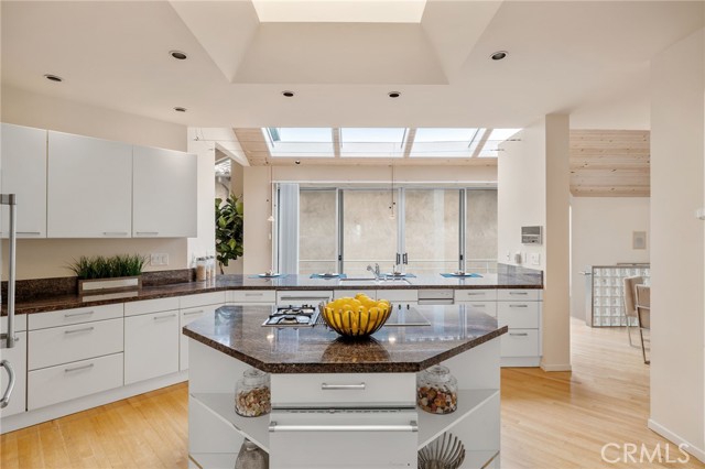 Kitchen with center island, breakfast bar and skylights.
