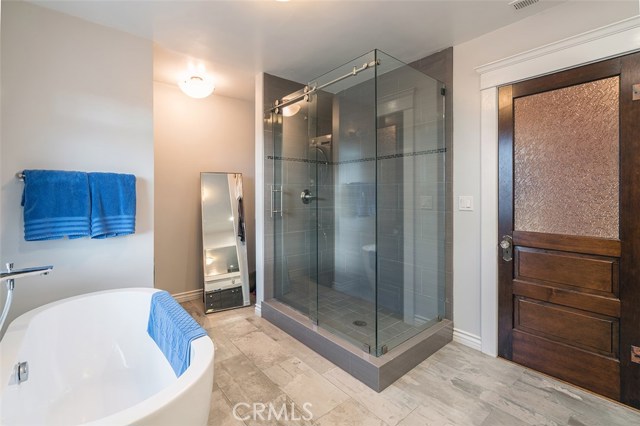 Upstairs newly remodeled bath with barn-door hinged glass shower enclosure