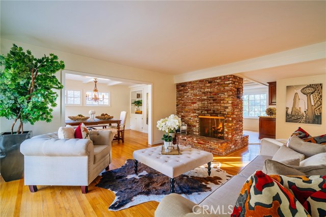 The living room features hardwood floors, warm fireplace and overlooks the lovely backyard.