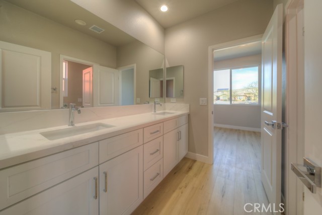 Double sink with quartz countertop and real wood soft close cabinets.