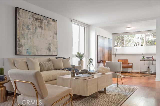 Living room extends to an extra area with large windows