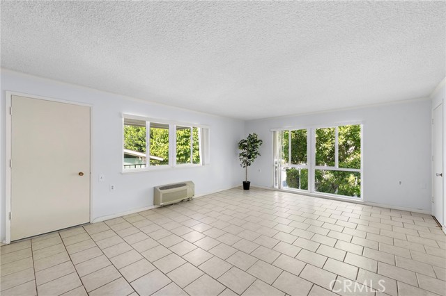 Lots of windows in the living room for your enjoyment of different views of the trees and neighborhood.
The door leads you out to the Balcony for your your convince and enjoyment. Opposite side Rm. extra closet space