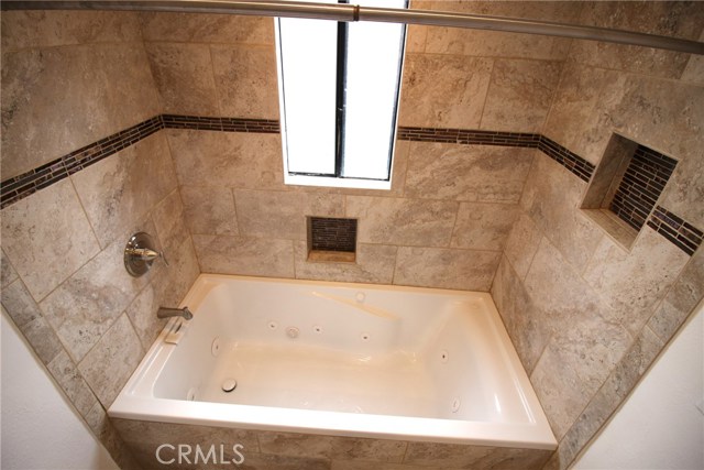 Master bath #2 with floor to ceiling travertine tile