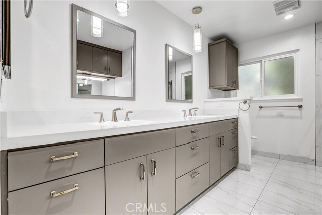 Upstairs shared bathroom with double sink
