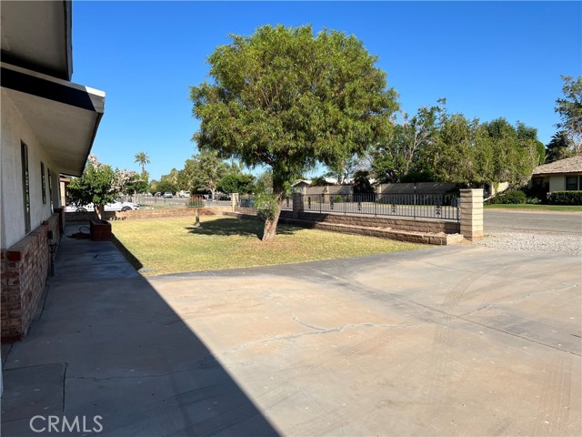 Landscaped yard with Slumpstone and Wrought iron fencing