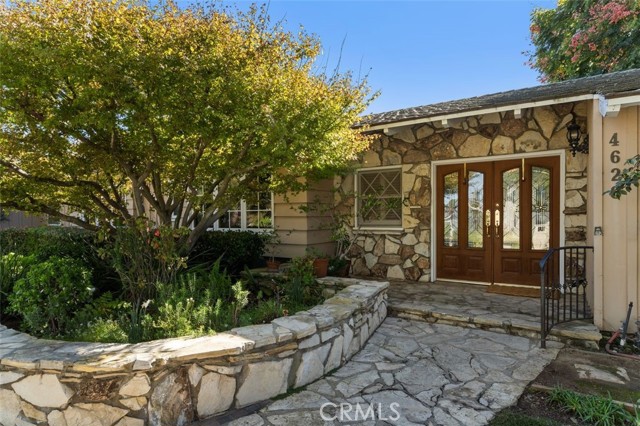 Gorgeous leaded glass double front doors greet the visitor.