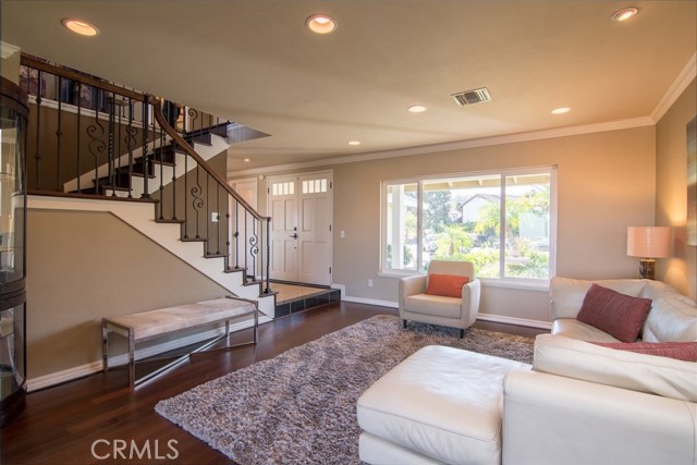 View of living room and elegant staircase