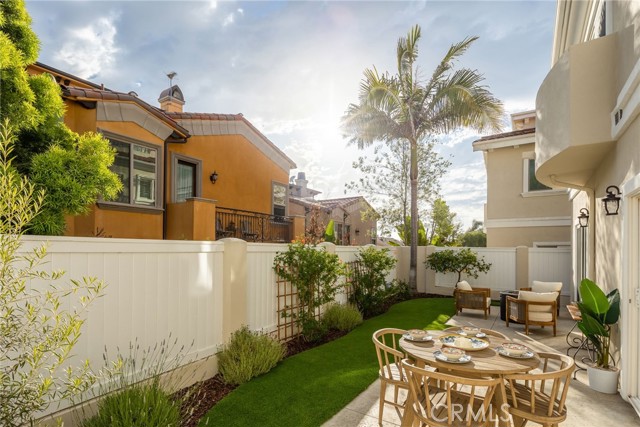 Ample rear yard with turf, mature landscaping and a lemon tree.