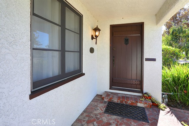 Yes! It is the original solid wood front door with art deco, peek a boo speak easy. An inviting front entry, complete with a old school mail drop.