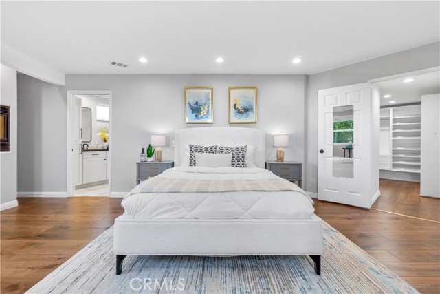 The elegant primary bedroom is a spacious suite where the Art Deco design continues.
