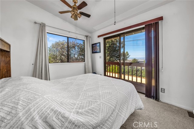 5th Bedroom with 3 windows and balcony.  Full bath to the left.