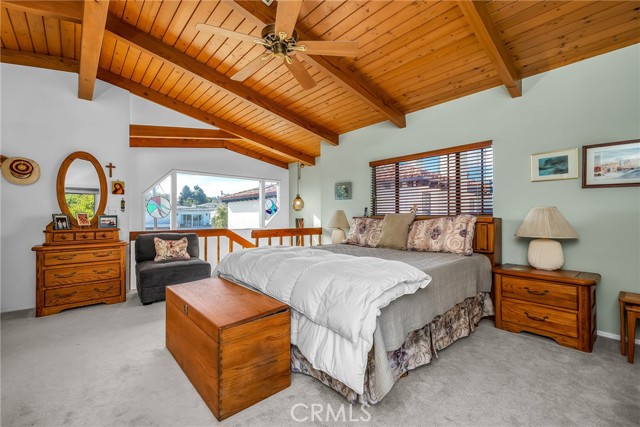 View #1 Master bedroom suite, with wood beam ceilings and a ceiling fan