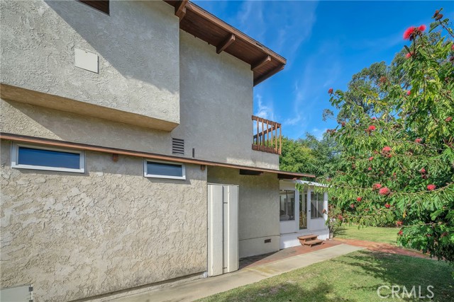 View of the home's east exterior.  You can see the enclosed porch and back yard