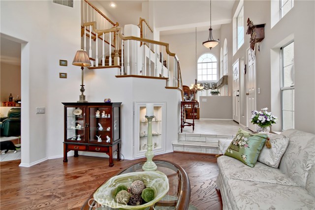 Living room looking toward front door and stairs up