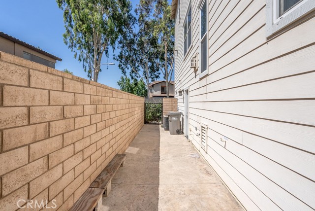 Patio leads to garage and rear of home