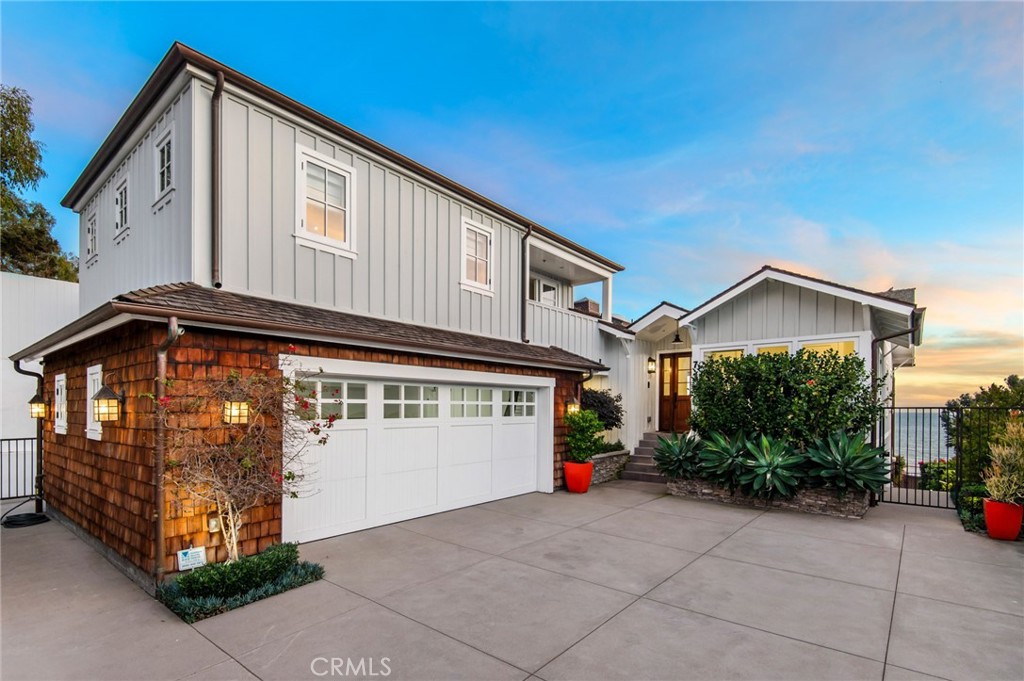 Breathtaking panoramas of the Pacific Ocean, meticulously revived interiors, and elevated outdoor living combine to create a quintessential Anders Lasater Architects-designed coastal retreat. Nestled within the coveted Fisherman’s Cove, Cliff Drive offers a meticulously refreshed contemporary aesthetic coupled with the privacy of a perched lot. Blending elegance and comfort, the main level features an open great room concept with access to a large deck with a fireplace. The ocean-facing living and dining areas flow seamlessly into the home’s gourmet kitchen, allowing for effortless everyday enjoyment or entertaining on special occasions. Below, a more casual secondary living room shares the floor with two of the home’s ensuite bedrooms. The primary suite is a luxurious haven with a marble-clad bathroom complete with a standalone tub, walk-in shower, and an oversized closet. Airy and bright, the owner's bedroom offers access to a large patio with an in-ground jacuzzi, multiple sitting areas, and a fire pit. The remaining secondary sleeping quarters include an upper-level retreat with its own living area complete with a wet bar, a fireplace, and an ocean-facing balcony. Amenities of this home include a two-car garage and a gated motor court. Iconic views, immaculate interiors, and a fantastic location near all Laguna Beach is known for create the ultimate coastal haven.