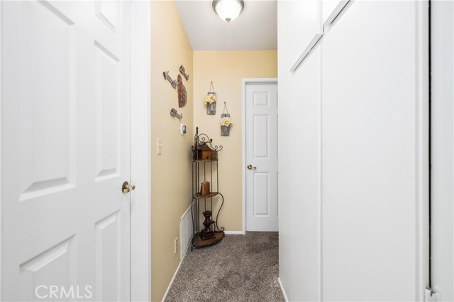 Hallway leading to the bathroom and two bedrooms.