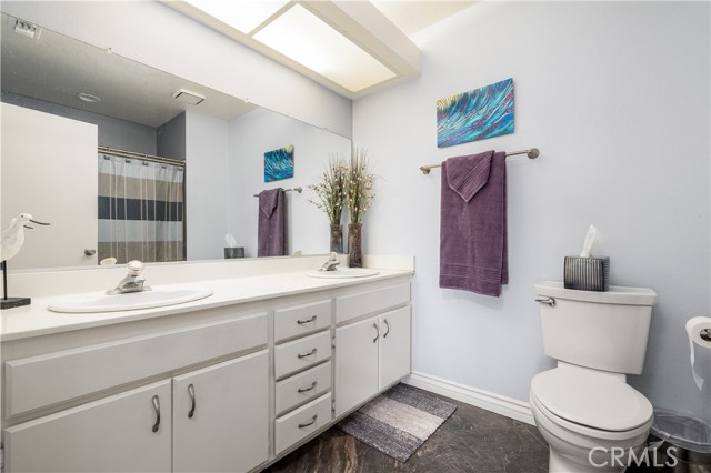 Secondary bathroom with double sink vanity.