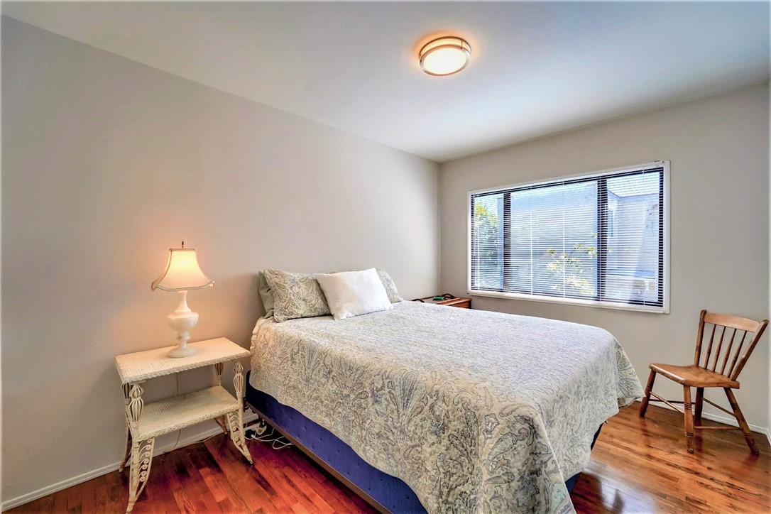 The third bedroom has hardwood floors and overlooks the rear yard and pool