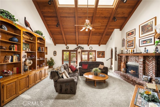 Spacious Family Room with Vaulted Wood Ceilings and Cozy Fireplace