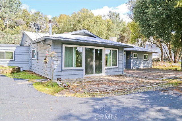 Driveway circles around to large carport