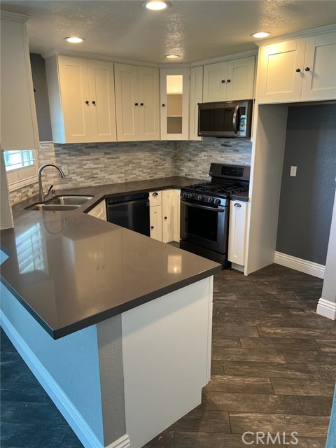 Quartz Counters with Modern Cabinets, Tile Flooring