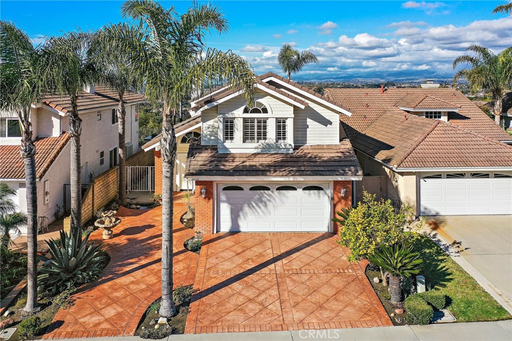 The breathtaking 180-degree views from this residence are sure to leave a lasting impression. Perched in the highly desirable Niguel Ranch neighborhood.  This home overlooks the serene landscape and city lights of Laguna Niguel, complete with palm and lemon trees.  As you step inside, natural light floods the living area, offering glimpses of the surrounding beauty. The open floor plan seamlessly integrates the kitchen, living, and dining areas, accentuated by high ceilings and spaciousness. Newly renovated kitchen with brand new appliances.  The family room is grounded with a fireplace that provides a cozy retreat, the neutral stone flooring and plantation shutters elevate the aesthetic of the home and provide a neutral decor. The catwalk upstairs enhances the open feel and connects the three bedrooms, each boasting plantation shutters. The primary bedroom offers stunning views of city lights and mountains. Its retreat features dual sinks, a separate tub, walk-in shower, walk-in closet and a water closet.  While the two secondary bedrooms share a full bathroom, ensuring comfort and convenience.  Outside, the backyard presents a blank canvas for outdoor gathering and entertaining. Residents can enjoy community walking trails and nearby amenities such as parks that include  tennis and basketball courts. Hidden Hills Elementary School is merely blocks away, minutes from beaches, shopping, entertainment, and other top-tiered schools. With no Mello Roos this is the house you have been dreaming of coming home to.